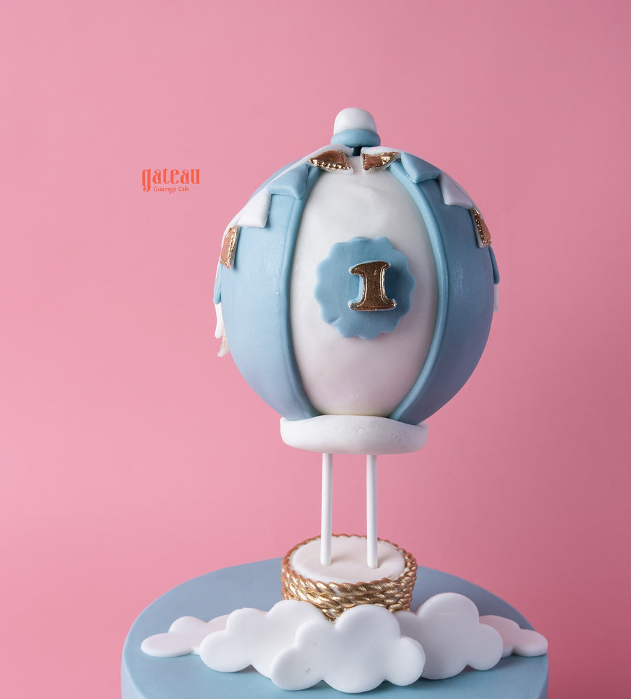 Customized air balloon themed cake from Gateau Gourmet Cafe with blue accents and a number one decoration