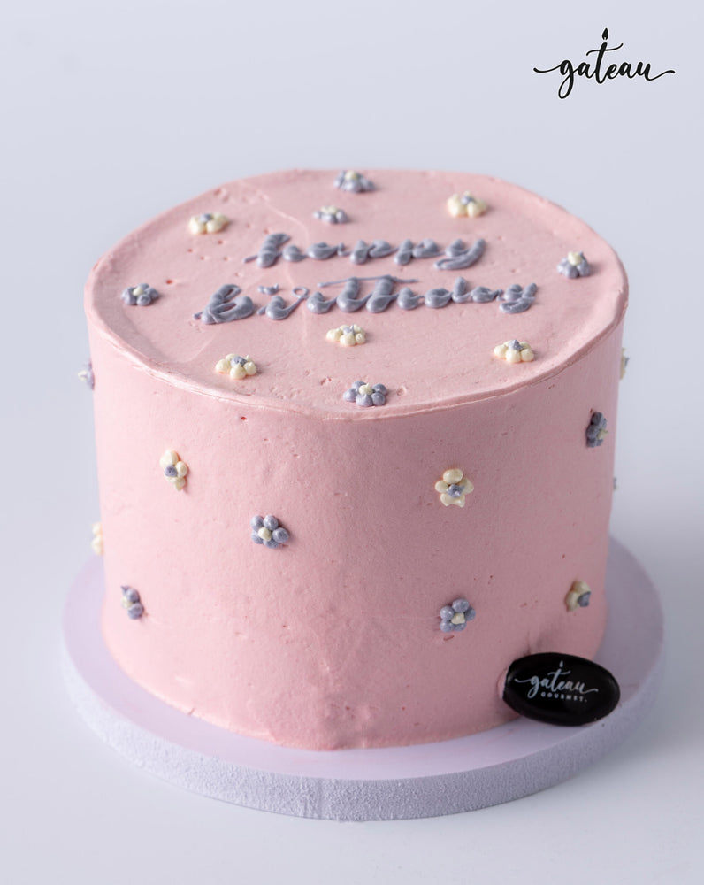 Gateau Gourmet Cafe pink birthday cake for girls with floral decorations and happy birthday text