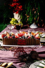 Gateau Gourmet Cafe fruit brownies dessert topped with festive fruits and holiday decorations