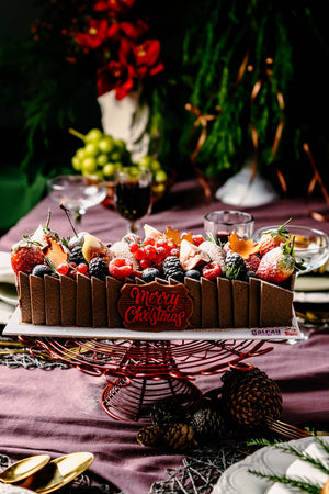 Gateau Gourmet Cafe fruit brownies dessert topped with festive fruits and holiday decorations