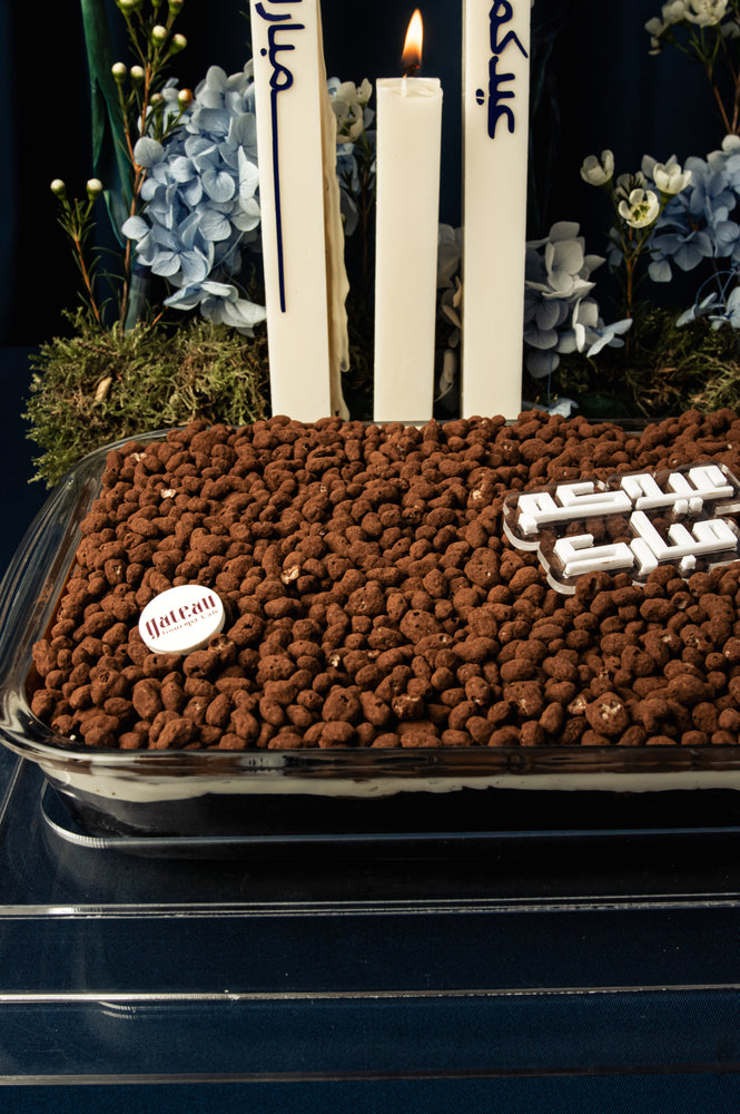 Eid Mubarak cake delivery featuring chocolate layers topped with decorative nuts and candles