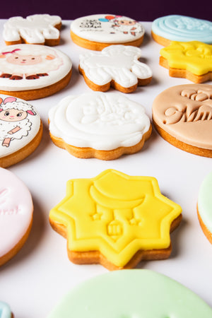 Colorful Gateau Gourmet Cafe Eid Mubarak cookies with moon, star, and festive designs on white background
