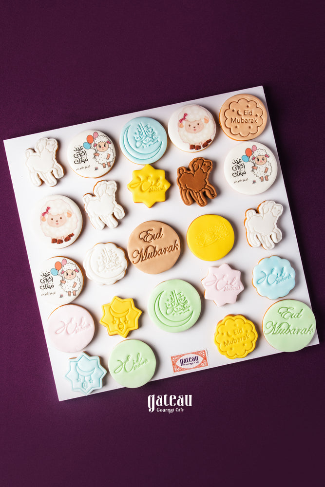 Assorted colorful Eid Mubarak cookies including stars, lambs, and festive designs from Gateau Gourmet Cafe