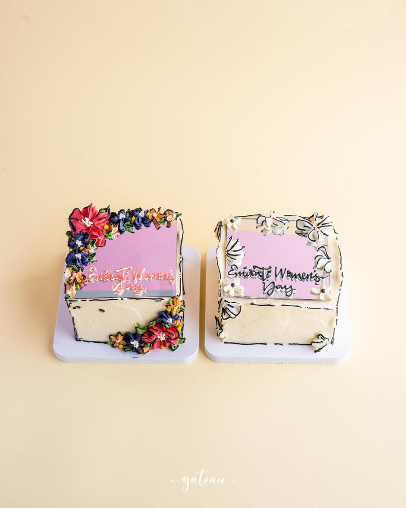 Gateau Gourmet Cafe mirror cake for special occasions decorated with colorful flowers and Elegant Women Day text