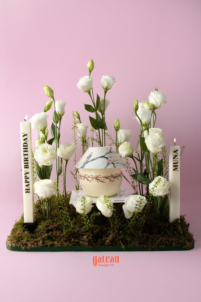 Eustoma flower cake arrangement by Gateau Gourmet Cafe, featuring candles and fresh flowers