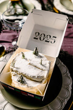 Gateau Gourmet Cafe festive desserts for Christmas cake topped with powdered sugar and rosemary in a 2023 box