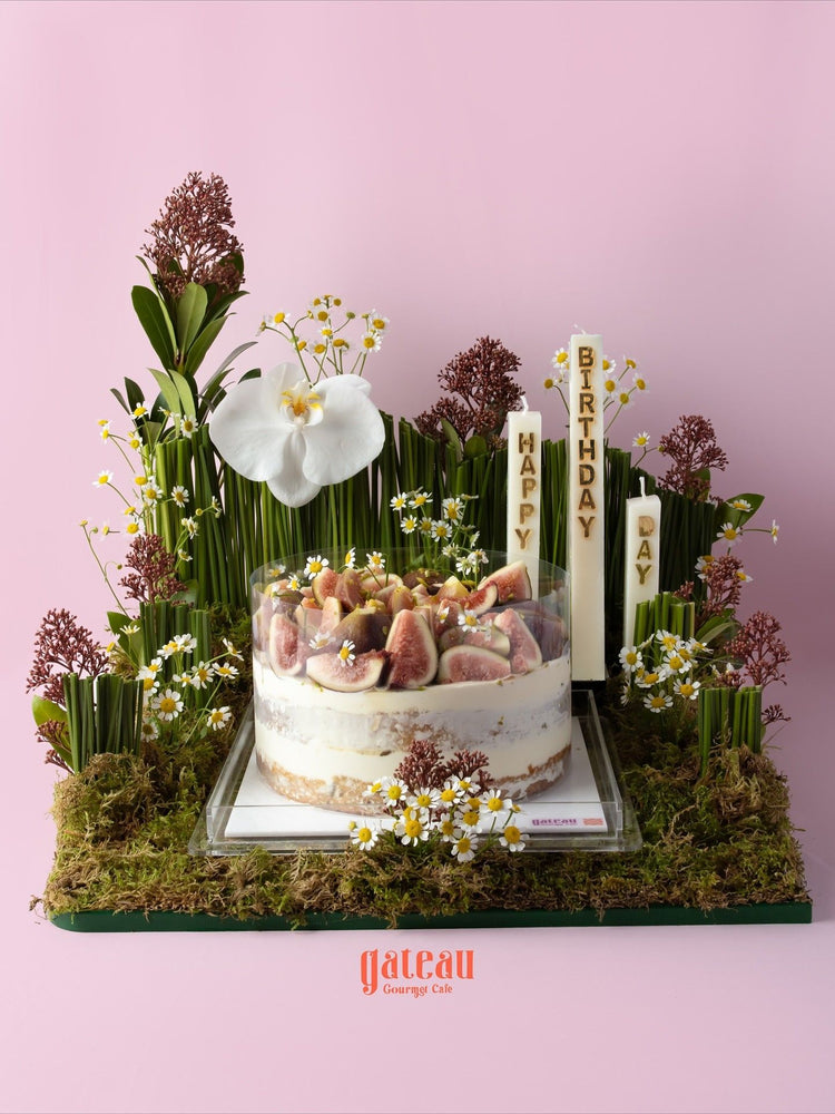 Elegant fig cake arrangement with fresh figs and flowers, perfect for birthday celebrations