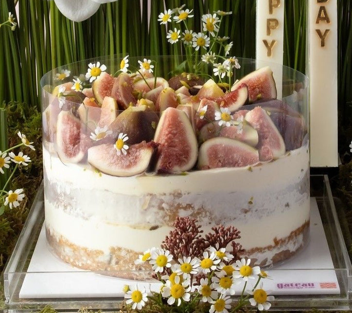 Elegant fig cake arrangement with fresh figs and floral decorations for a celebratory occasion