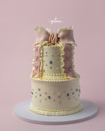 Two-tier delicate Fionka cake with pastel floral decorations and pink ribbon detailing for Fionka cake delivery