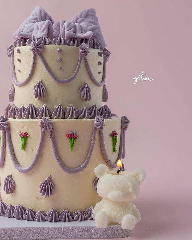 Gateau Gourmet Cafe Fionka cake for special occasions with lavender decorations and a bear-shaped candle