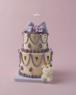 Fionka cake for special occasions by Gateau Gourmet Cafe decorated with purple bows and a teddy bear candle
