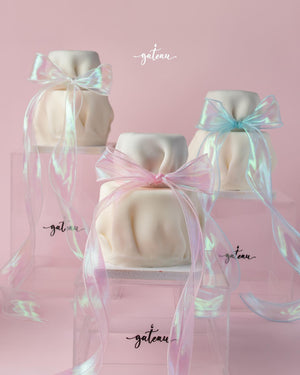 Fionka gourmet cake by Gateau Gourmet Cafe wrapped in white fondant with pastel ribbon bows