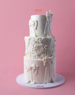 Elegant floral-texture-ribbons-cake with intricate designs and bows for special celebrations