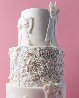 Elegant floral-texture-ribbons-cake with intricate floral designs and ribbon accents from Gateau Gourmet Cafe