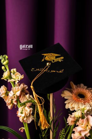 Flork Graduate Cake Design with Arrangement featuring a graduation cap and fresh flowers in a vibrant setting