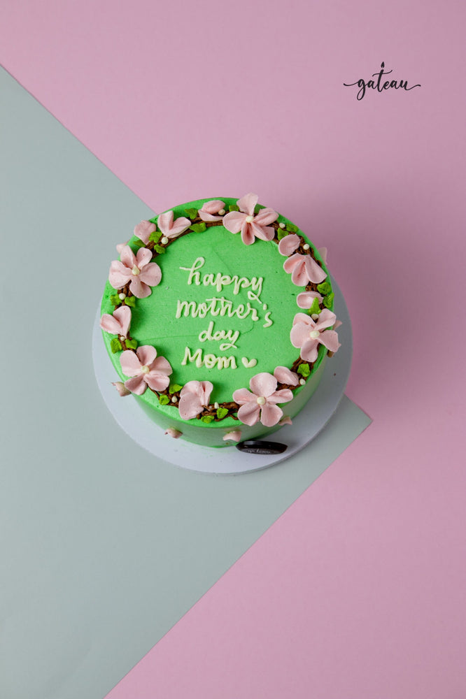 Flower Crown Cake for Mom with green frosting and pink flowers from Gateau Gourmet Cafe