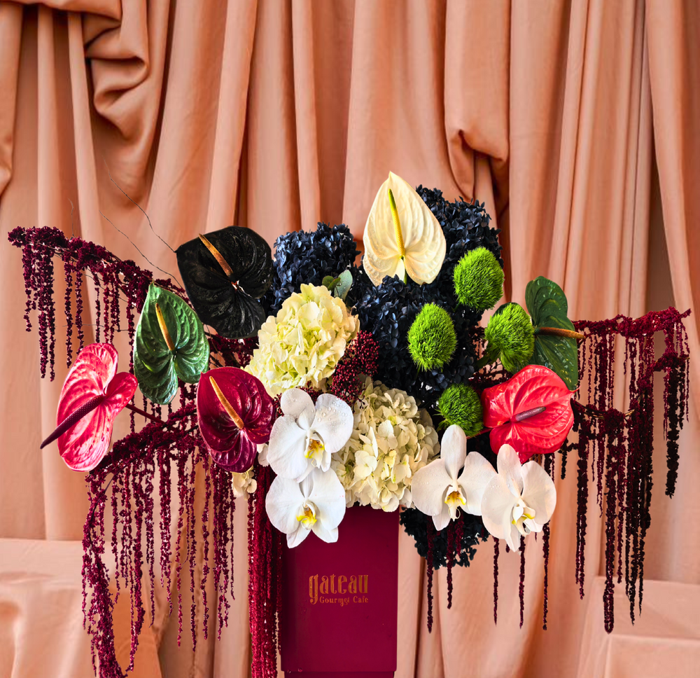 Beautiful National Day flower arrangement with vibrant orchids and lush greenery in a stylish box
