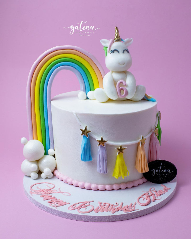 Fun lol-candy-theme-cake featuring a unicorn, rainbow, and colorful decorations for birthdays