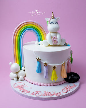 Fun lol-candy-theme-cake featuring a unicorn, rainbow, and colorful decorations for birthdays