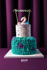Gateau Gourmet Cafe 2nd birthday cake ideas with colorful textured bottom and purple top tier candle