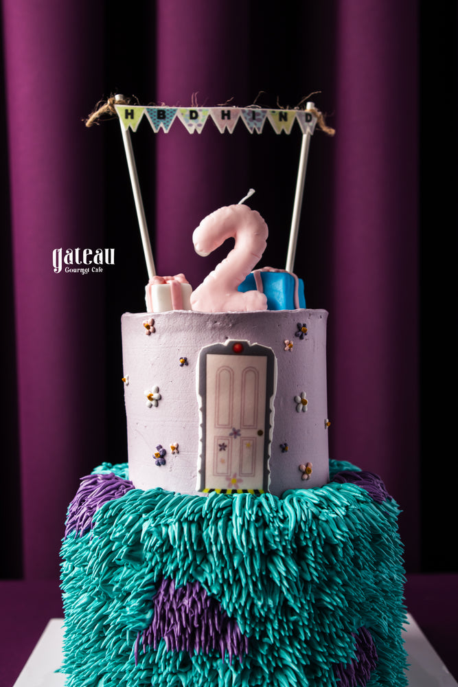 Gateau Gourmet Cafe 2nd birthday cake ideas with purple and teal textured frosting and number two candle