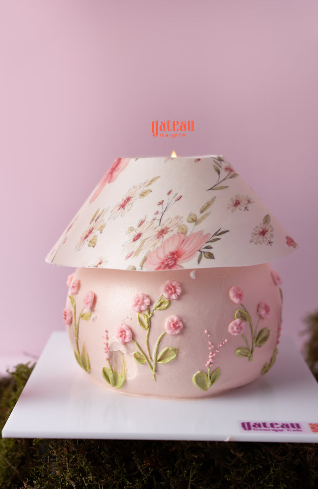 Pink cake with floral decorations, featuring an anthurium flower cake arrangement, from Gateau Gourmet Cafe