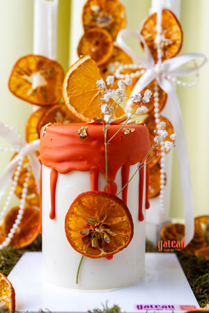 Artisan cakes for special occasions by Gateau Gourmet Cafe with orange drip icing and dried orange decoration