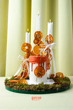 Artisan cakes for special occasions with red drip icing and dried orange decorations by Gateau Gourmet Cafe