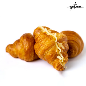 Gateau Gourmet Cafe artisan cheese croissant with golden flaky layers topped with shredded cheese