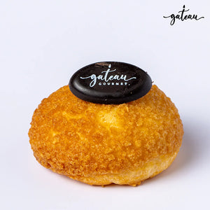 Gateau Gourmet Cafe artisan choux pastry with a golden crispy exterior topped with a chocolate logo plaque