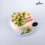 Delicious birthday cake decorated with baby-rose-bundle and colorful icing for celebration