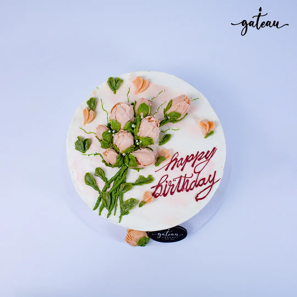 Beautiful baby-rose-bundle birthday cake with floral decorations and a cheerful message