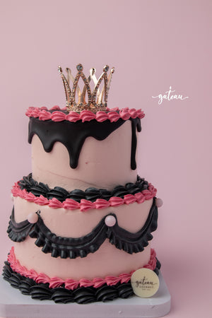Gateau Gourmet Cafe Barbie birthday cake with pink frosting black drip and decorative crown topper