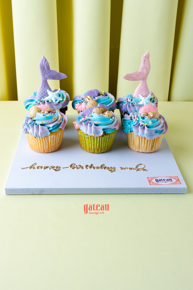 Gateau Gourmet Cafe cupcakes decorated with beach inspired cupcake flavors featuring mermaid tails and seashell designs