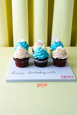 Gateau Gourmet Cafe cupcakes featuring beach inspired cupcake flavors with blue and beige frosting swirls
