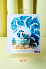 Gateau Gourmet Cafe beach themed birthday cake with ocean waves and dolphin decoration