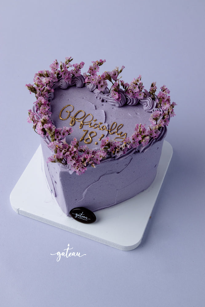 Heart-shaped lavender birthday cake with floral decoration from Gateau Gourmet Cafe for birthday cake delivery service