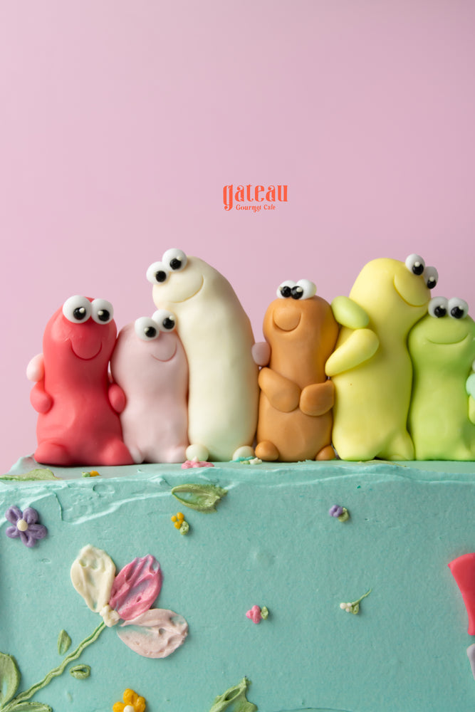 Colorful birthday cake for best friend with playful fondant characters at Gateau Gourmet Cafe