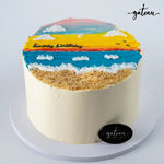 Gateau Gourmet Cafe birthday cake with beach design featuring sand, ocean, sky, and clouds