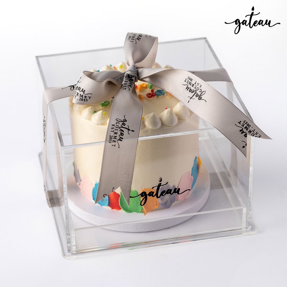 Delicious birthday cake from Gateau Gourmet Cafe in a clear box, perfect for birthday cakes delivery