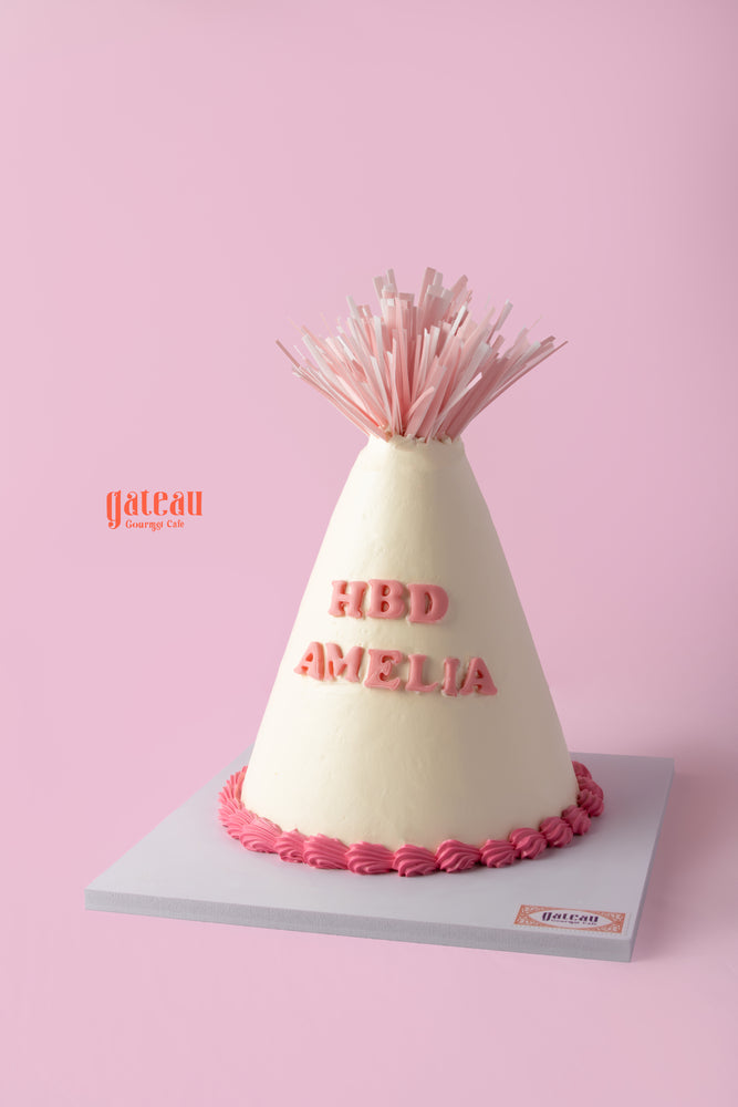 Delicious birthday party hat cake from Gateau Gourmet Cafe with vibrant pink details and personalized message
