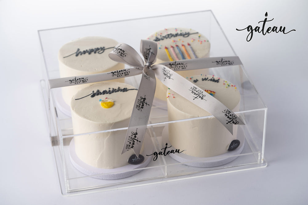 Gateau Gourmet Cafe birthday wish cake set with four small decorated cakes in clear box and ribbon