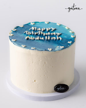 Blue ombre cake with white frosting and birthday message by Gateau Gourmet Cafe
