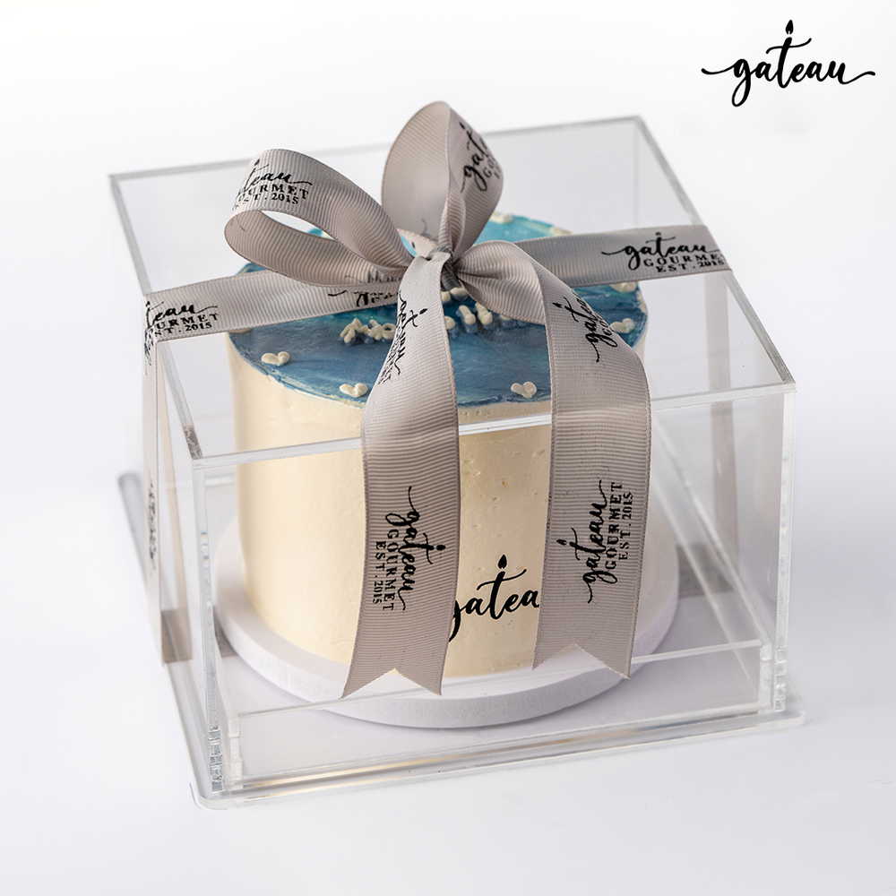 Gateau Gourmet Cafe blue ombre cake in clear gift box with decorative ribbon and logo