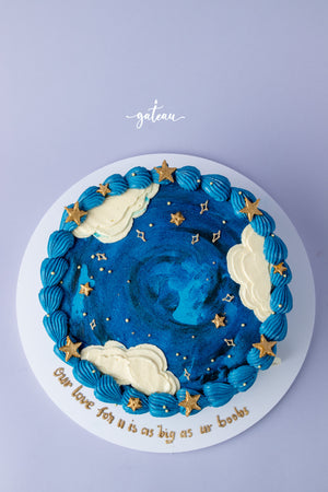 Gateau Gourmet Cafe blue sky cake design decorated with clouds and golden stars on white plate