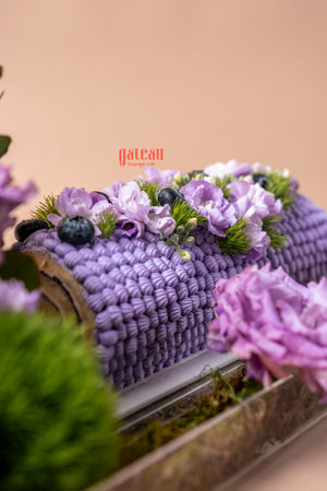 Beautiful blueberry cake floral arrangement with purple flowers and greenery from Gateau Gourmet Cafe
