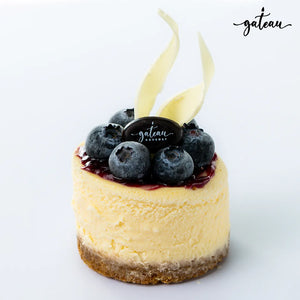 Blueberry cheesecake dessert with fresh blueberries and white chocolate curls from Gateau Gourmet Cafe