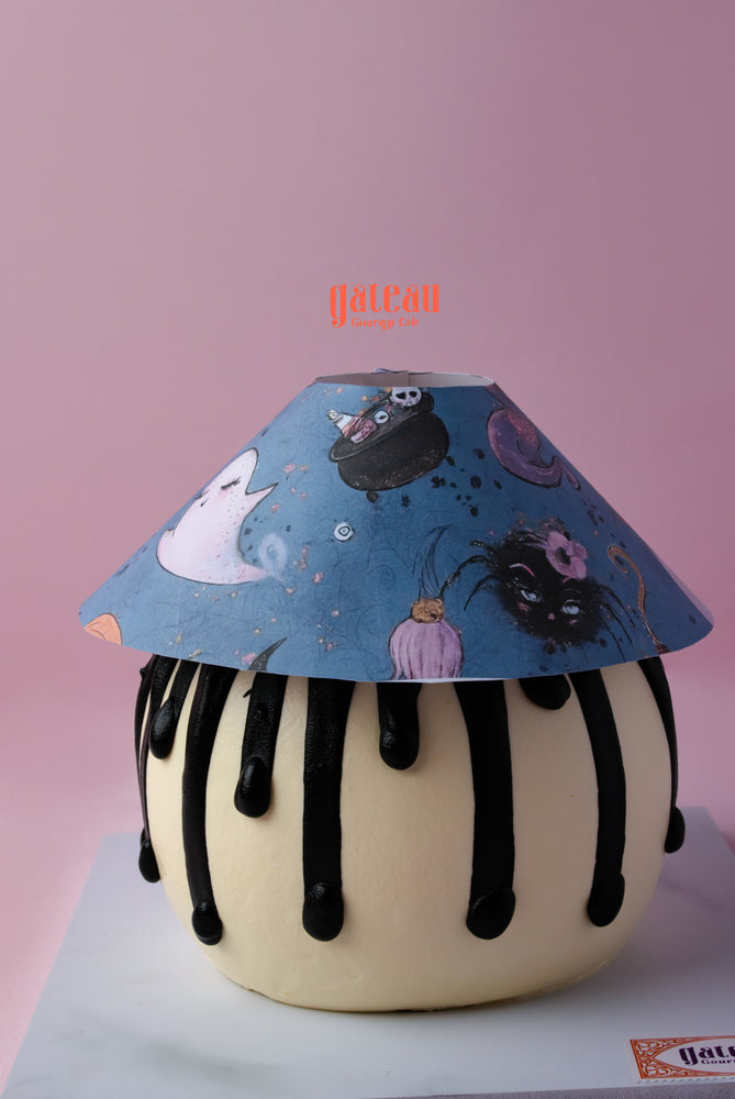 Boo-tiful Lamp Cake for parties featuring a whimsical design with ghosts and black cats