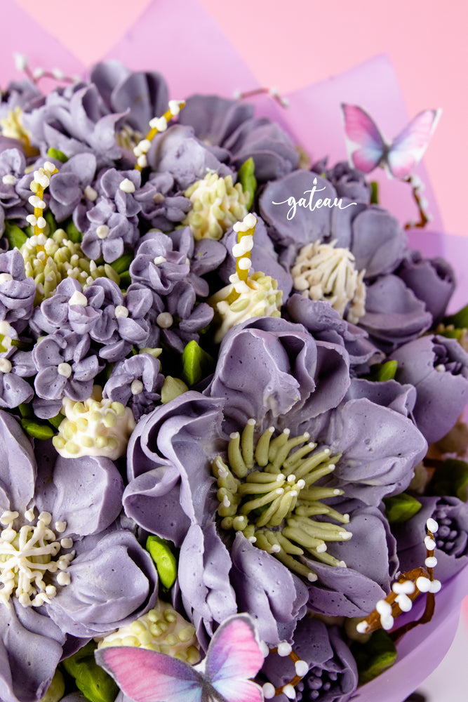 Gateau Gourmet Cafe bouquet cake for special occasions with purple flower frosting and decorative butterflies