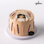 Bride to be cake with beige frosting decorated with floral designs and a bride figure on top by Gateau Gourmet Cafe